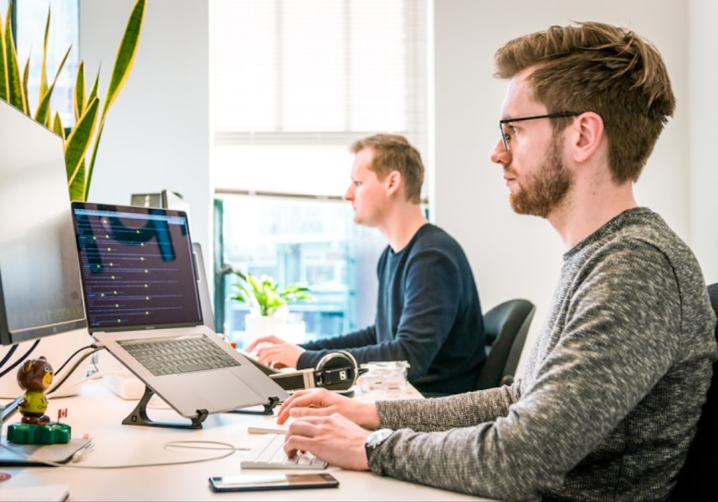 Professionals working on laptops in a modern office